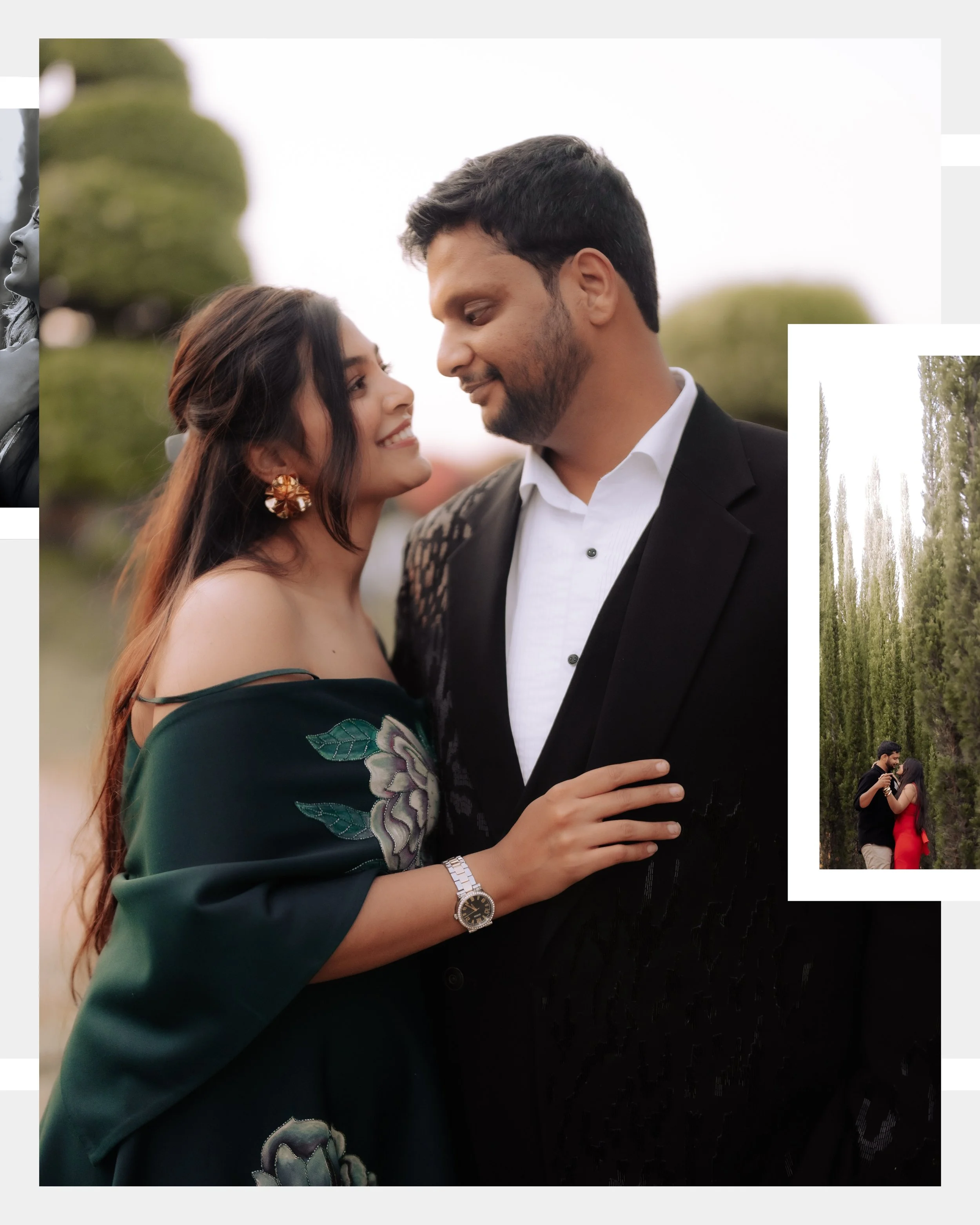 A couple is standing close together outdoors. The woman has long brown hair, wears earrings, a watch, and embroidery on her dark green dress. The man has dark hair, a beard, and is dressed in a black suit with a white shirt. They are smiling and gazi