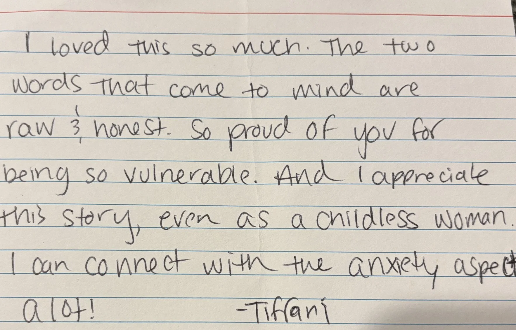 Close-up of handwritten note on lined paper expressing love and pride, signed '-Tiffani'.