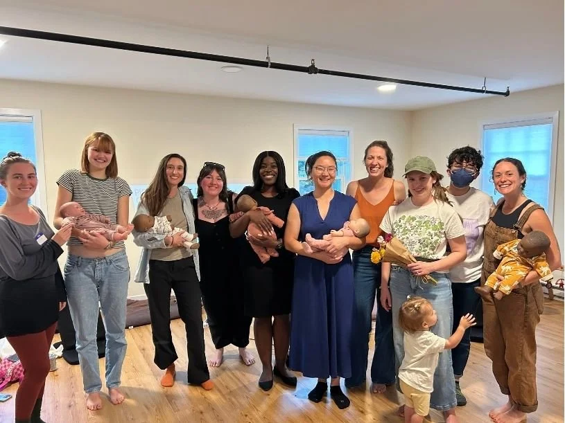 Pioneer Valley Doula Collaborative team, holding baby dolls