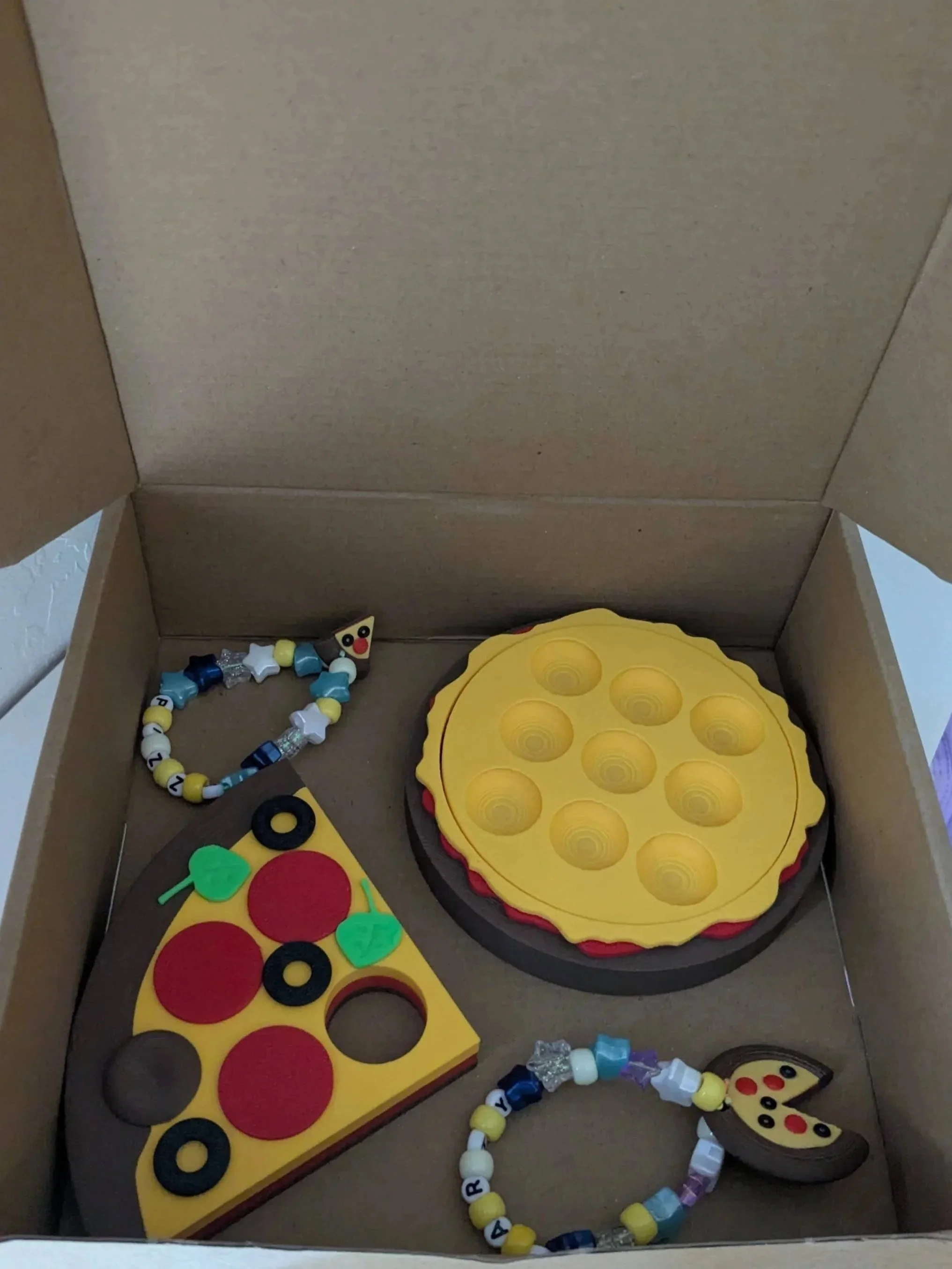 pizza bracelets with pizza charms, pizza book holder, and pizza tic tac toe