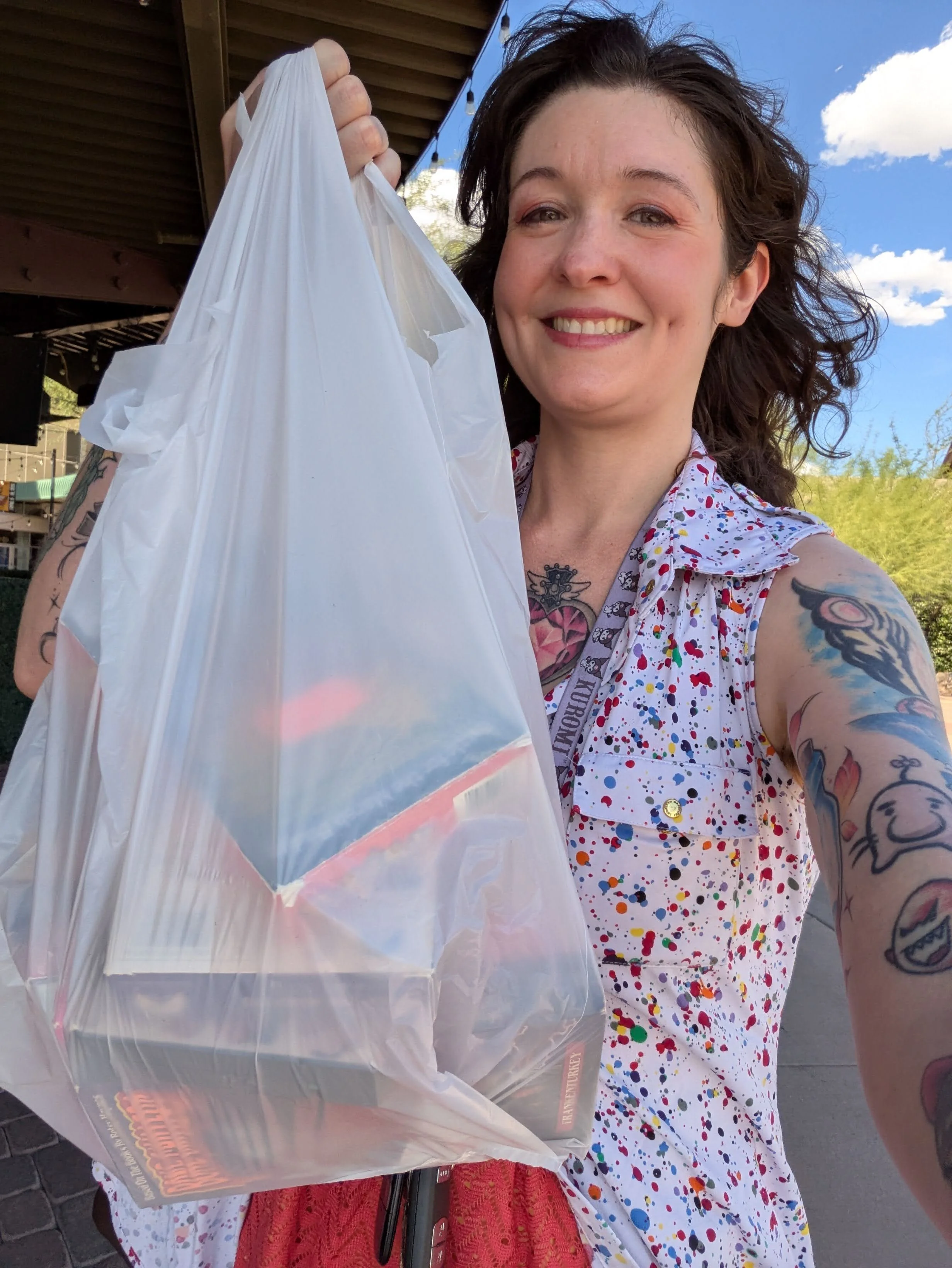 Katerina Dicker with a big bag of VHS tapes and beautiful blue skies and fluffy clouds