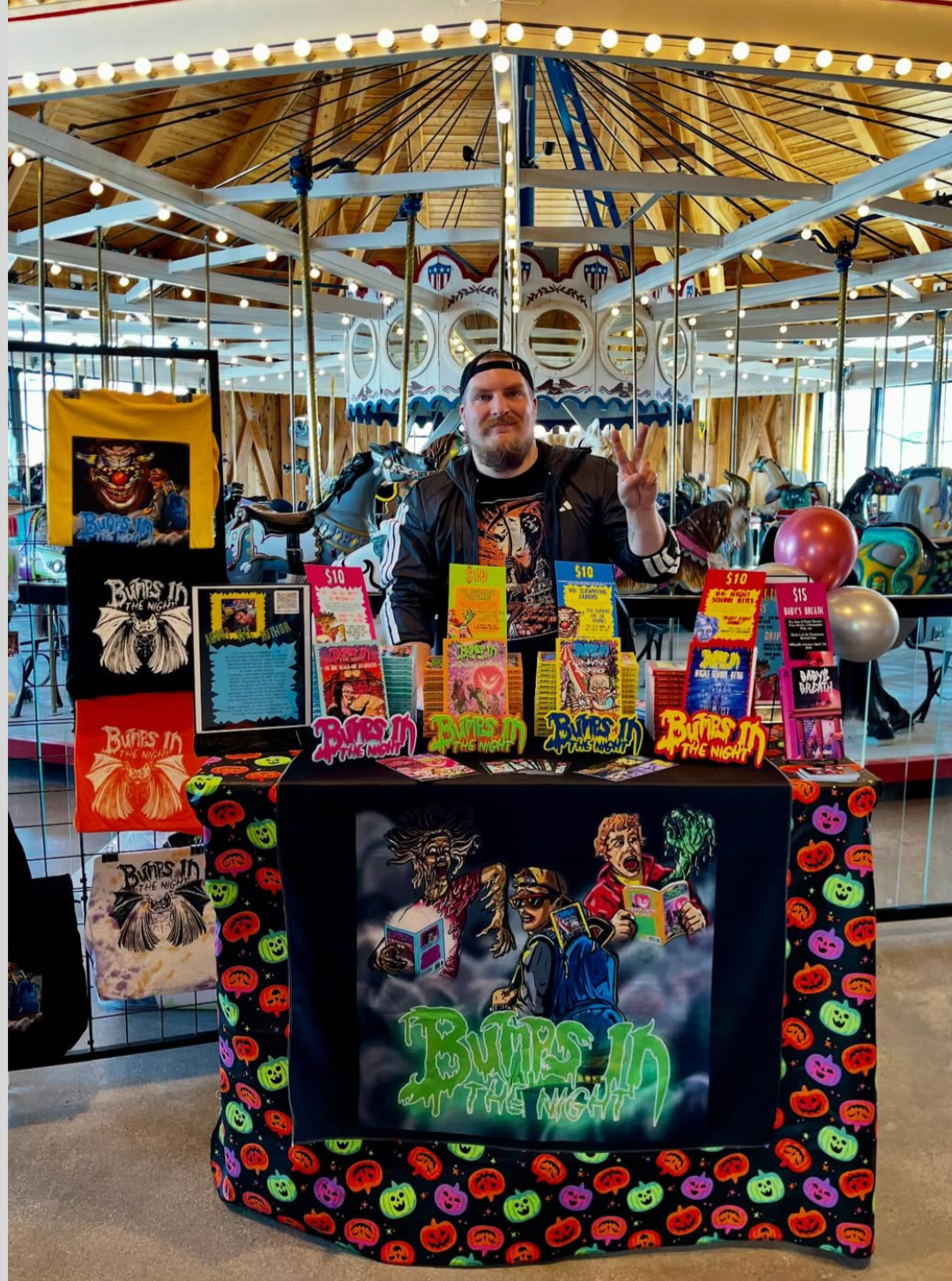 Author A.D. Aro with his books and merch