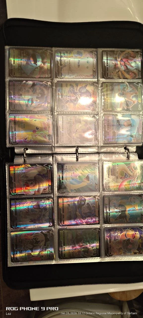A collection of Pokémon trading cards in a binder with 12 visible cards, featuring various characters with holographic effects.