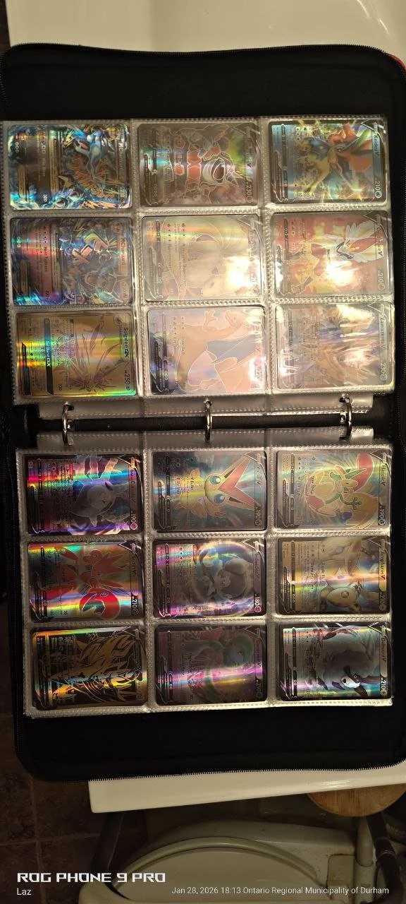 A collection of Pokémon trading cards in a binder, arranged in plastic sleeves, featuring various holographic and illustrated cards.