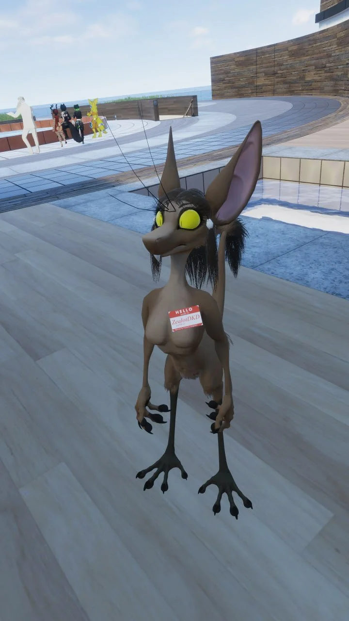 A humanoid fox character with large yellow eyes, long pointed ears, and black hair stands in an indoor area with wooden flooring and pool. The fox has an identification tag that reads 'HELLO ZealouDKD' and has a confident stance.