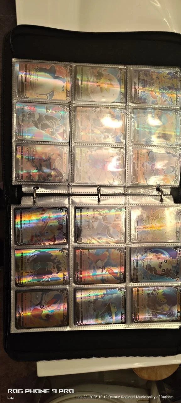 Collection of Pokémon trading cards in a binder, featuring various characters and holographic designs.