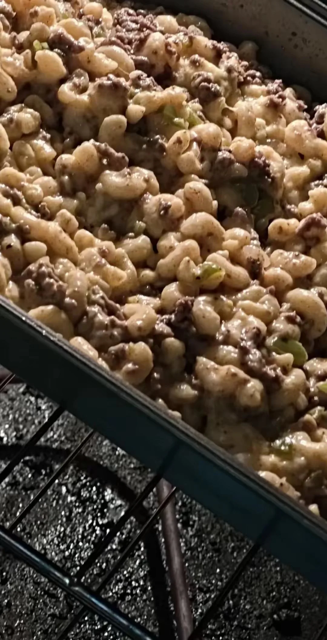 Roasted cauliflower and beef cooked in a pan on a grill.