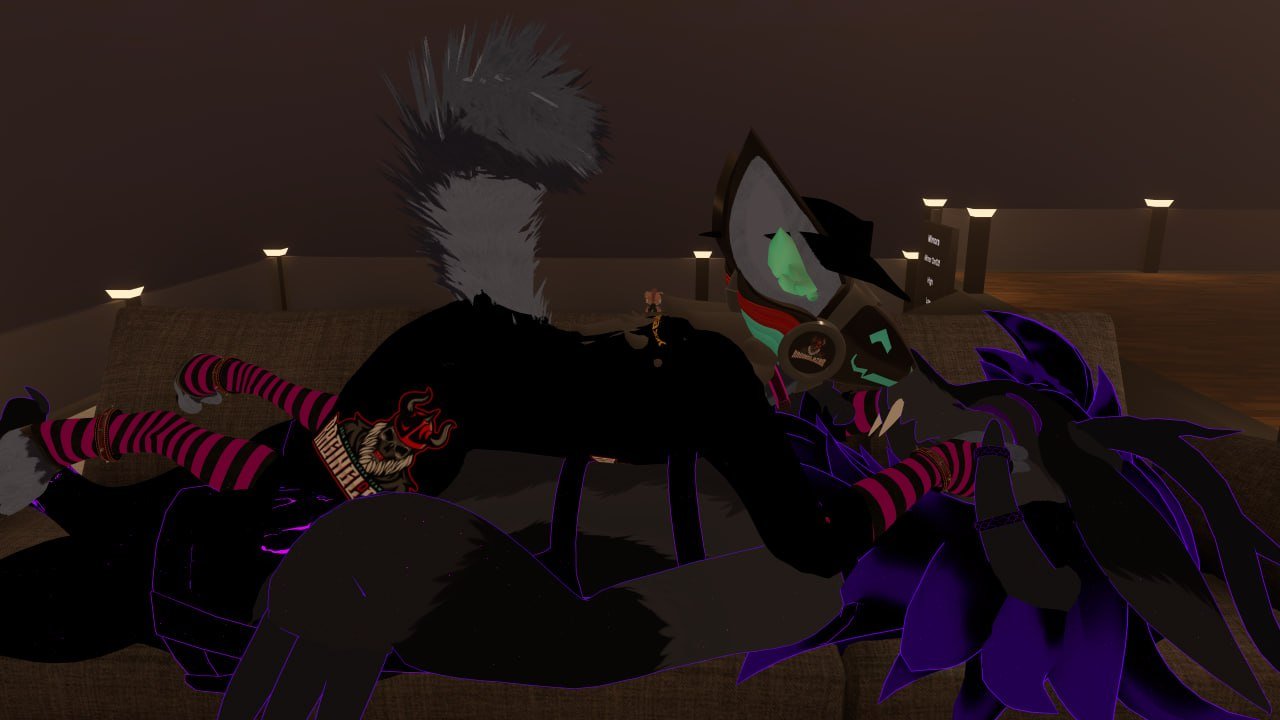Animated wolf and creature cuddling on a couch in a dimly lit room.