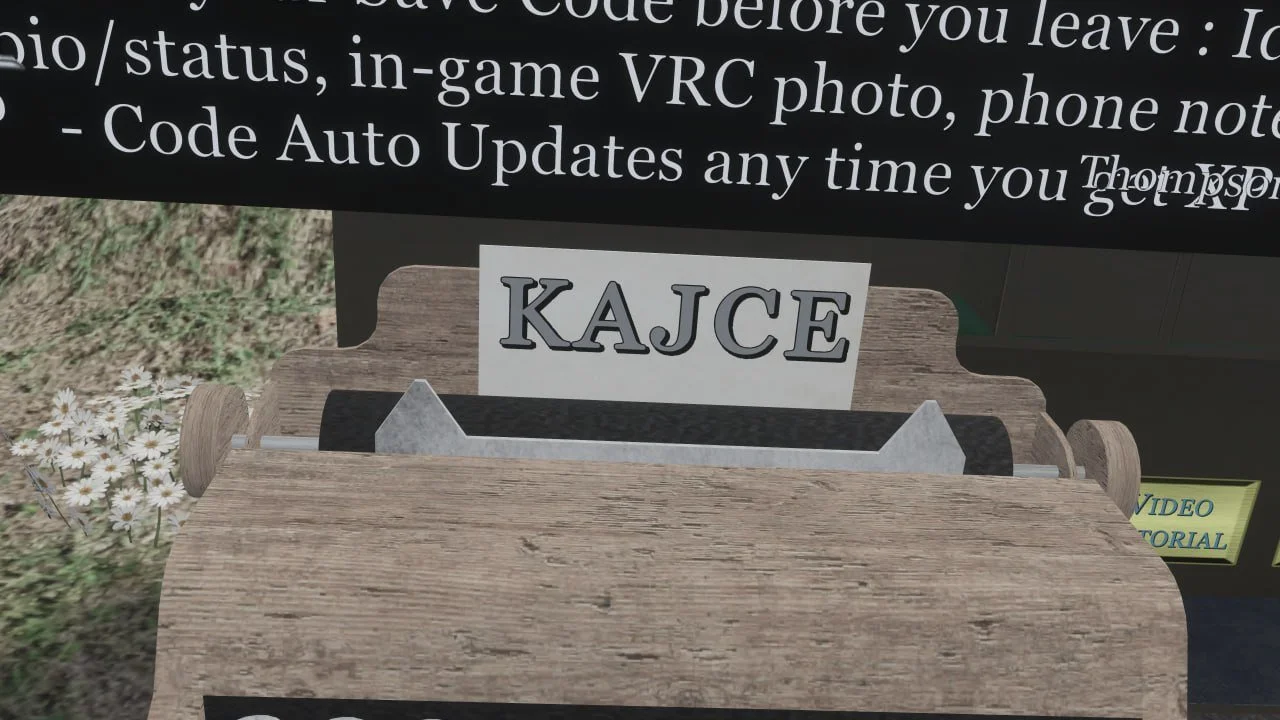 Wooden donation box with a white sign reading KAJCE, placed outdoors next to small white flowers.