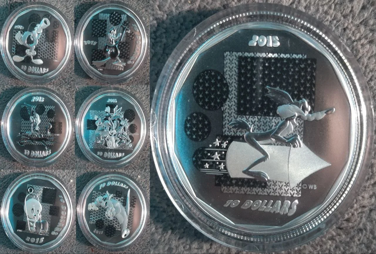 Collection of eight commemorative coins with Disney characters and designs, including Mickey Mouse, Pluto, and Donald Duck, each marked with '2015' and '10 DOLLARS'.