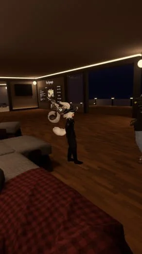 Interior of a modern apartment with a person holding a bicycle near a large window at night.