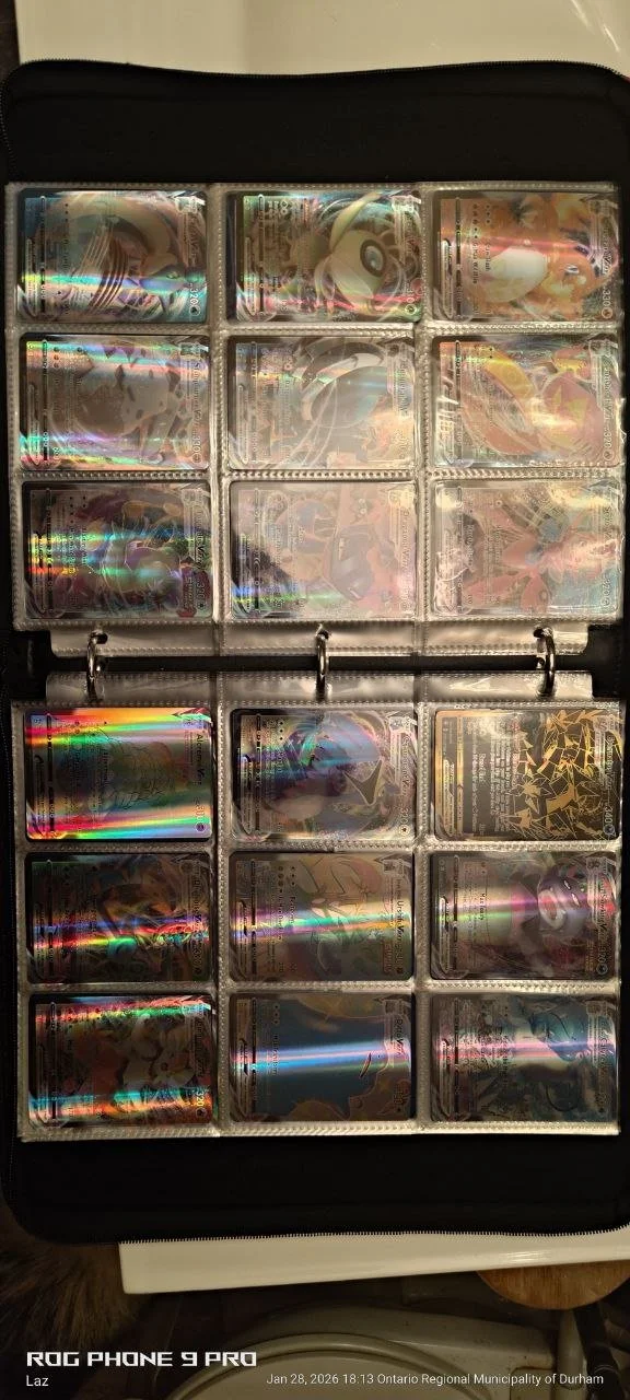 A collection of Pokémon trading cards organized in a plastic binder sleeve with three rows of cards, each containing six cards, featuring holographic and illustrated designs.