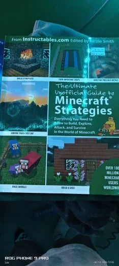 Cover of a book titled 'The Ultimate Unofficial Guide to Minecraft Strategies' with images of Minecraft scenes and gameplay on the cover.