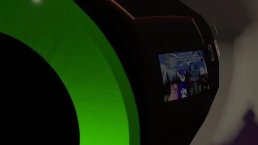 A close-up of a device with a black body and a green circular component, featuring a small screen displaying cartoon or animated characters.