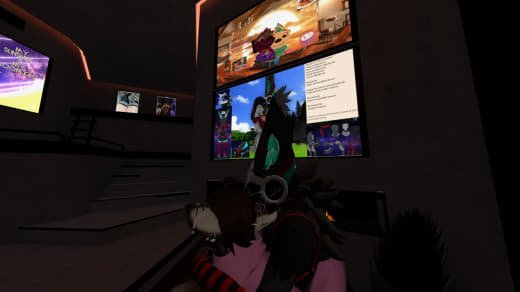 People in a virtual reality arcade wearing VR headsets and interacting with screens in a dark environment.