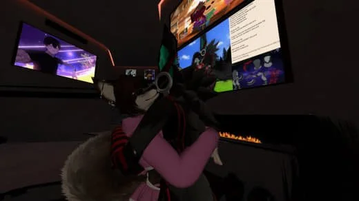 A person wearing a virtual reality headset in front of multiple computer screens with various images and videos.