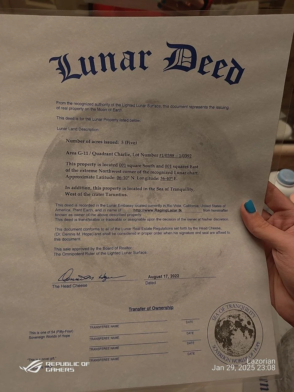 A Lunar Deed document titled 'Lunar Deed' with details about a property on the Moon, including acres, coordinates, and location in the Sea of Tranquility. The document has signatures, a date of August 17, 2022, and official seals, and is held by a ha