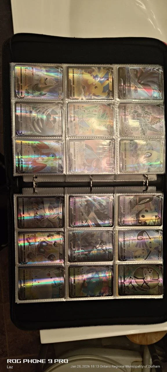 A collection of Pokémon cards stored in a binder with plastic sleeves, showing various holographic cards.