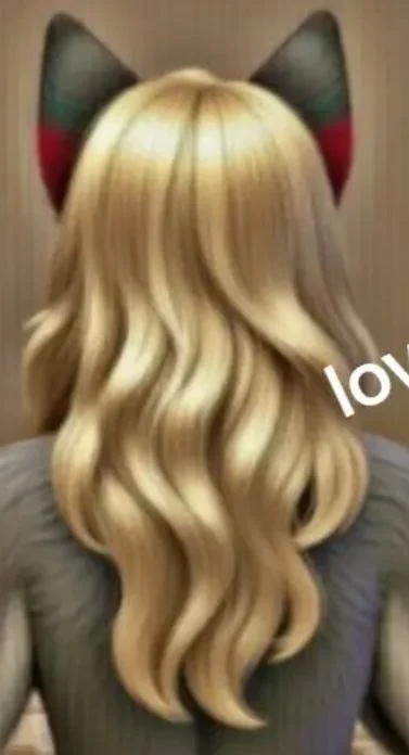 Person with long, wavy blonde hair wearing cat ear headband with red and green accents, facing away.
