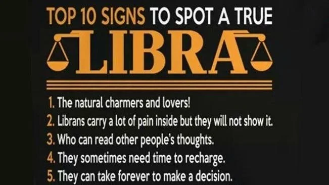 A black background sign listing the top 10 signs of a true Libra. The text is in white and orange, with a stylized Libra symbol at the top. The list includes traits like charm, hidden pain, reading others' thoughts, needing recharge time, and making 