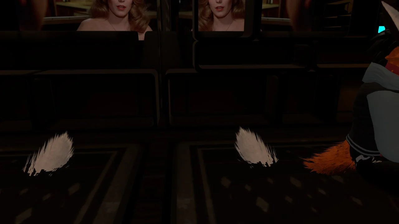 A woman with blonde hair looking at mirrors in a fitting room.