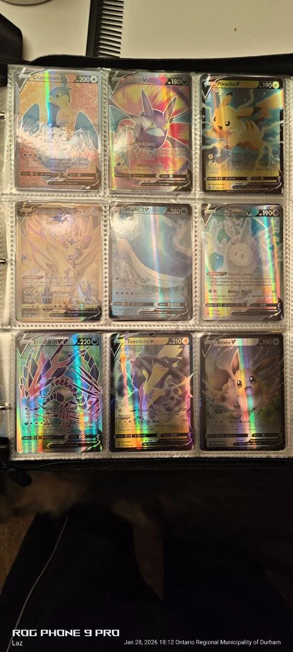 A collection of nine Pokémon cards in a plastic display sleeve, including Cramorant V, Venomous Fang Genesect V, Pikachu V, Zapdos V, Wailord, Snorlax G-Max, Eternatus V, Toxtricity V, and Eevee V.