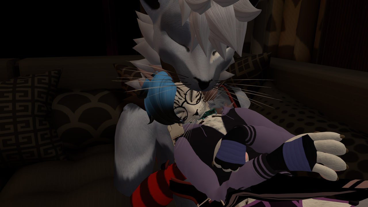 Computer-generated image of anthropomorphic animals in a cozy room with patterned pillows. One appears to be a lion or feline character with white hair, and the other is a smaller rodent or chipmunk, both engaging with each other.