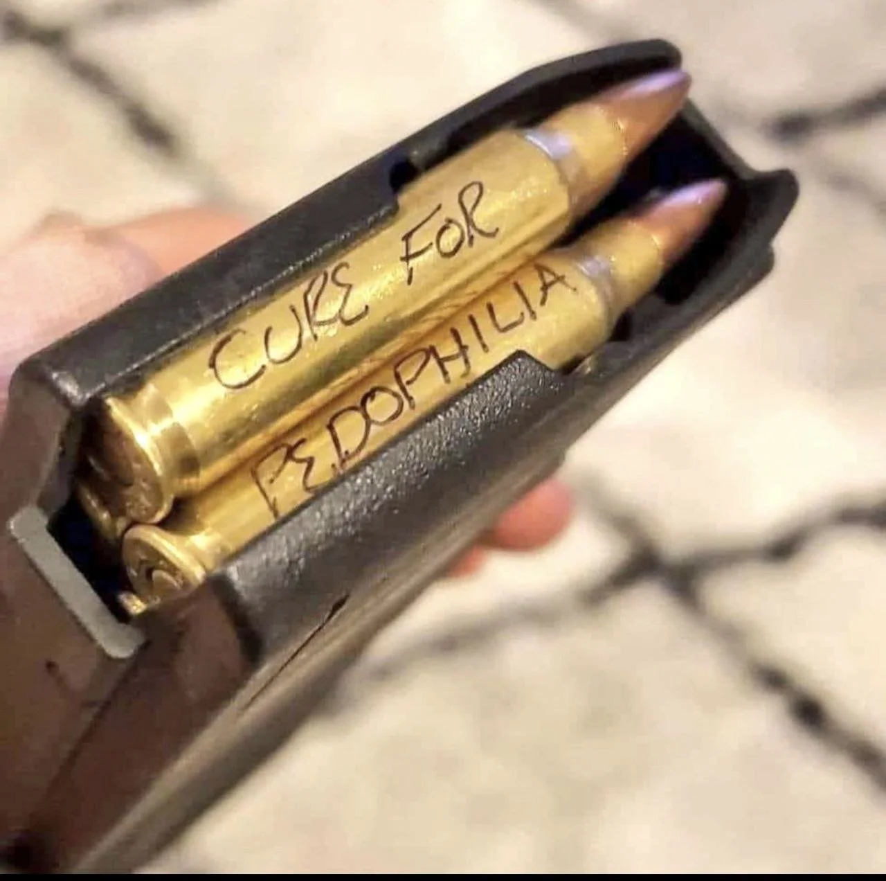Two brass-colored bullets inside a black box, with handwritten labels 'CURE FOR' and 'PSYPHILLIA' on them.
