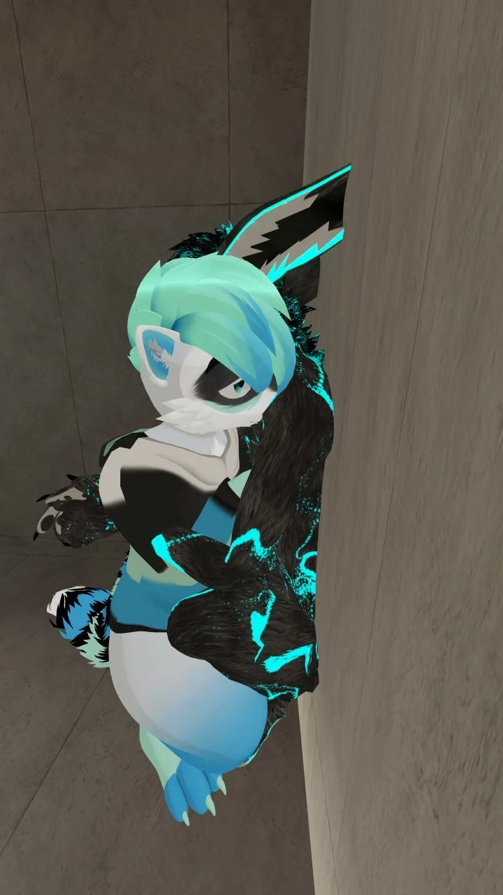 A character with turquoise hair, a wolf-like face with a black patch over one eye, and wearing a hoodie, standing against a beige-colored wall.