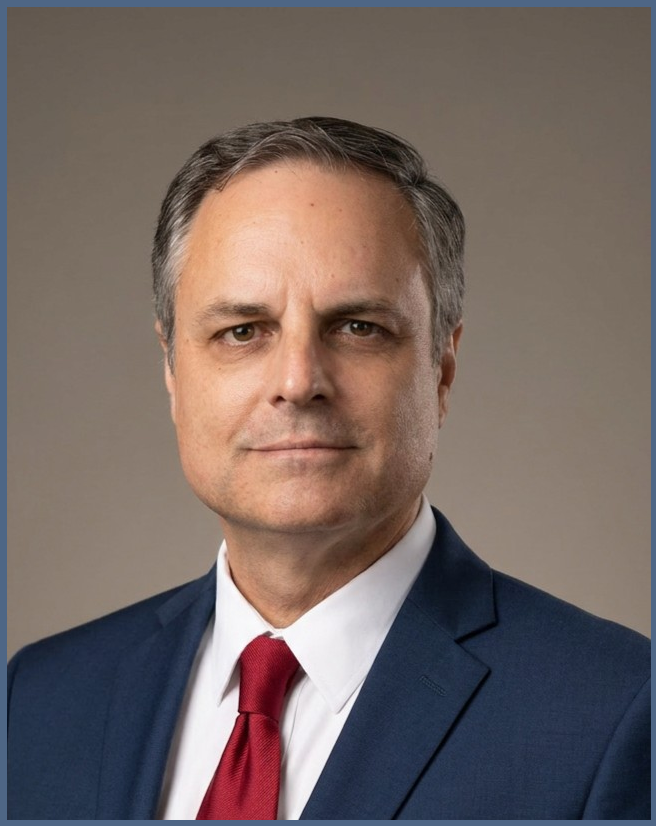 Headshot of Eric LaFleur, a board-certified family lawyer, wearing a blue suit and a red tie.