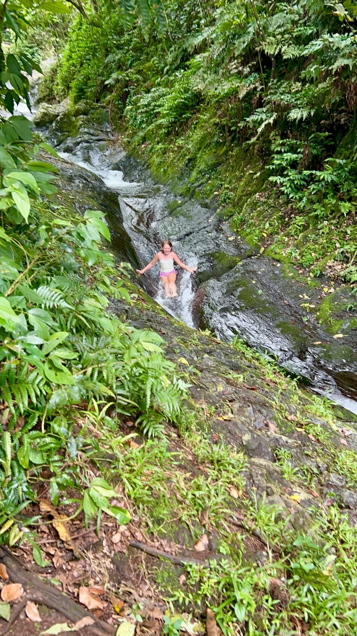 Teenage girl on the Slipery slide Waitavala Natural Swaterslide Activities to do in taveuni fiji