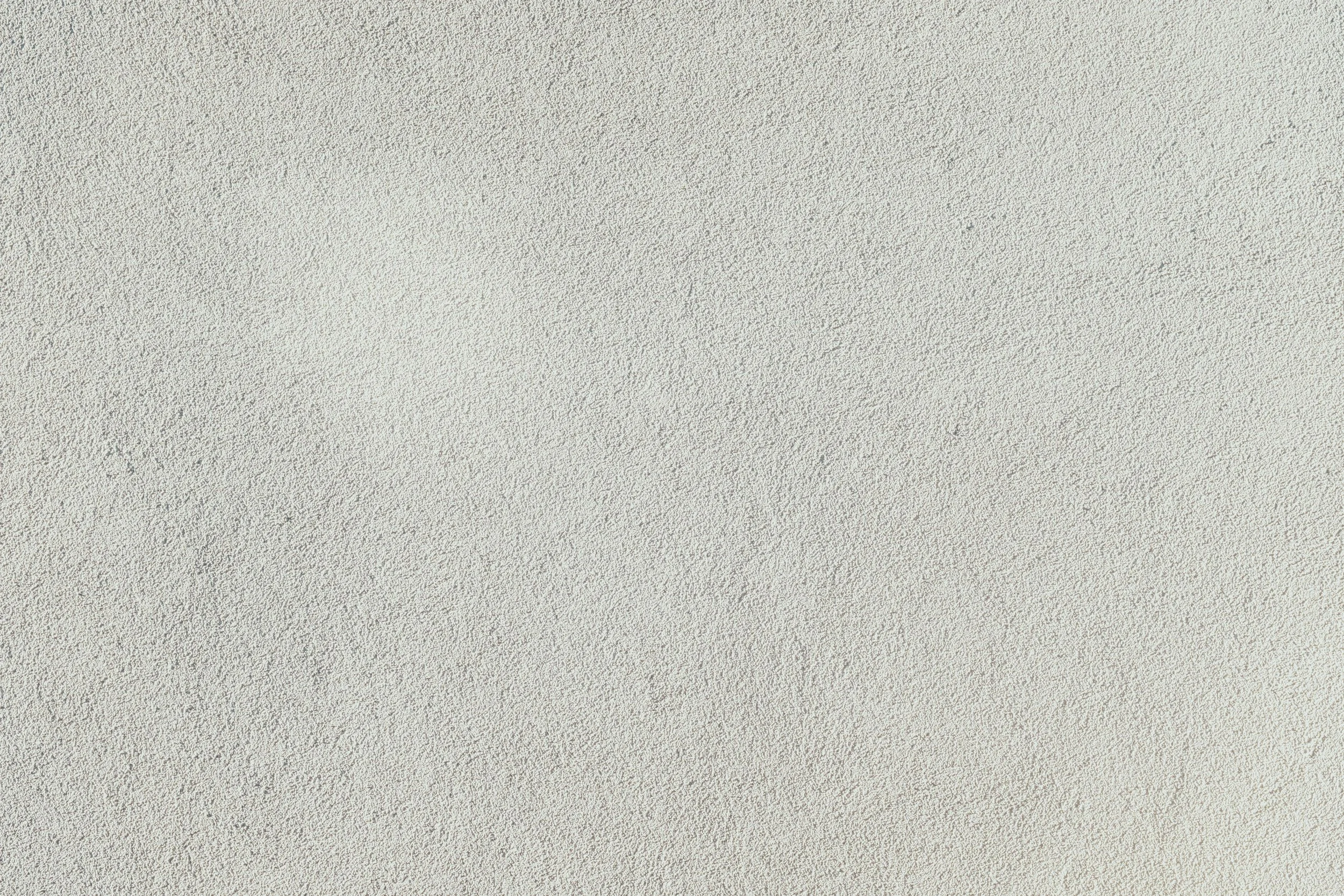 A plain, textured beige wall.