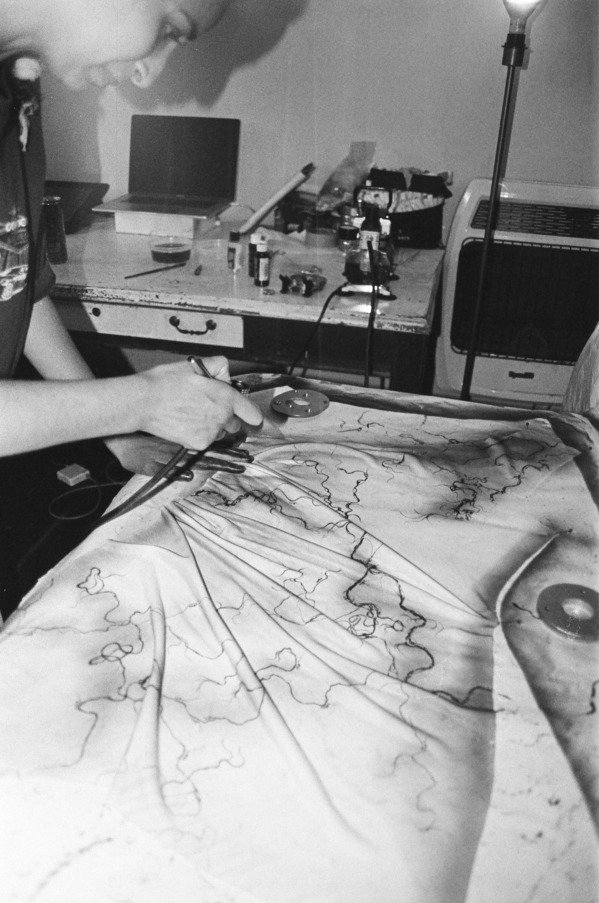 Gurleen Home Studio, airbrushing custom garments for N*S*F*W techno collective, New Orleans 2026