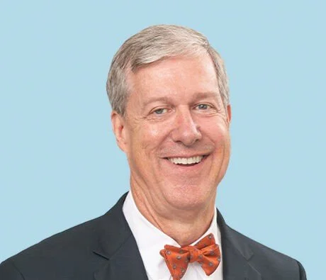 Headshot of smiling male tutor with medium-length black hair wearing a lanyard.