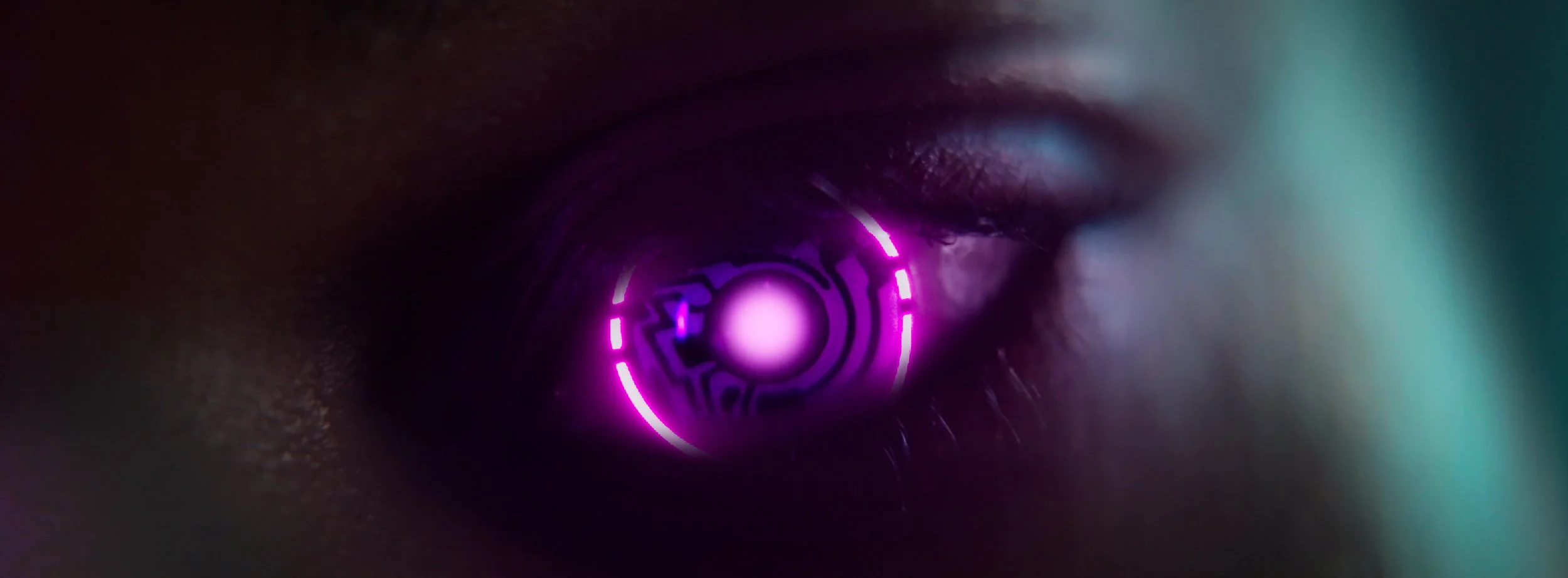 Close-up of a human eye with a glowing pink and purple futuristic or sci-fi design element reflected in the pupil.