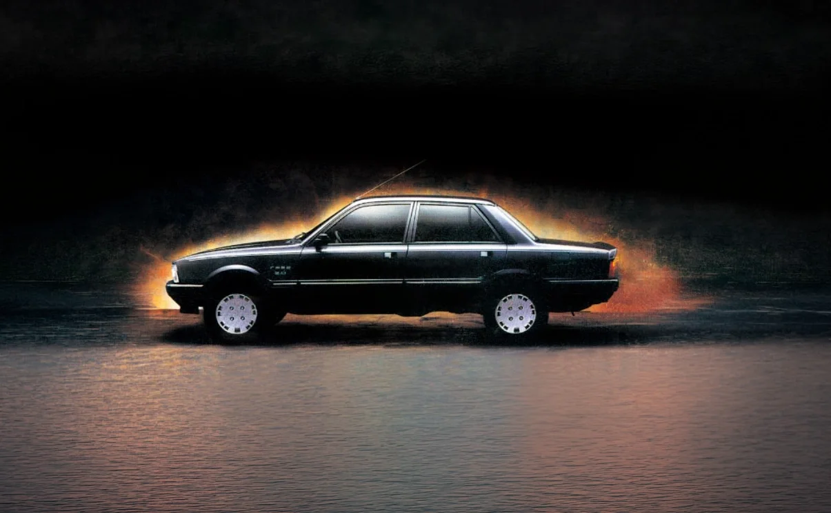 A black vintage sedan with glowing rims, parked on a wet surface at night, with flames in the background creating a dramatic effect.