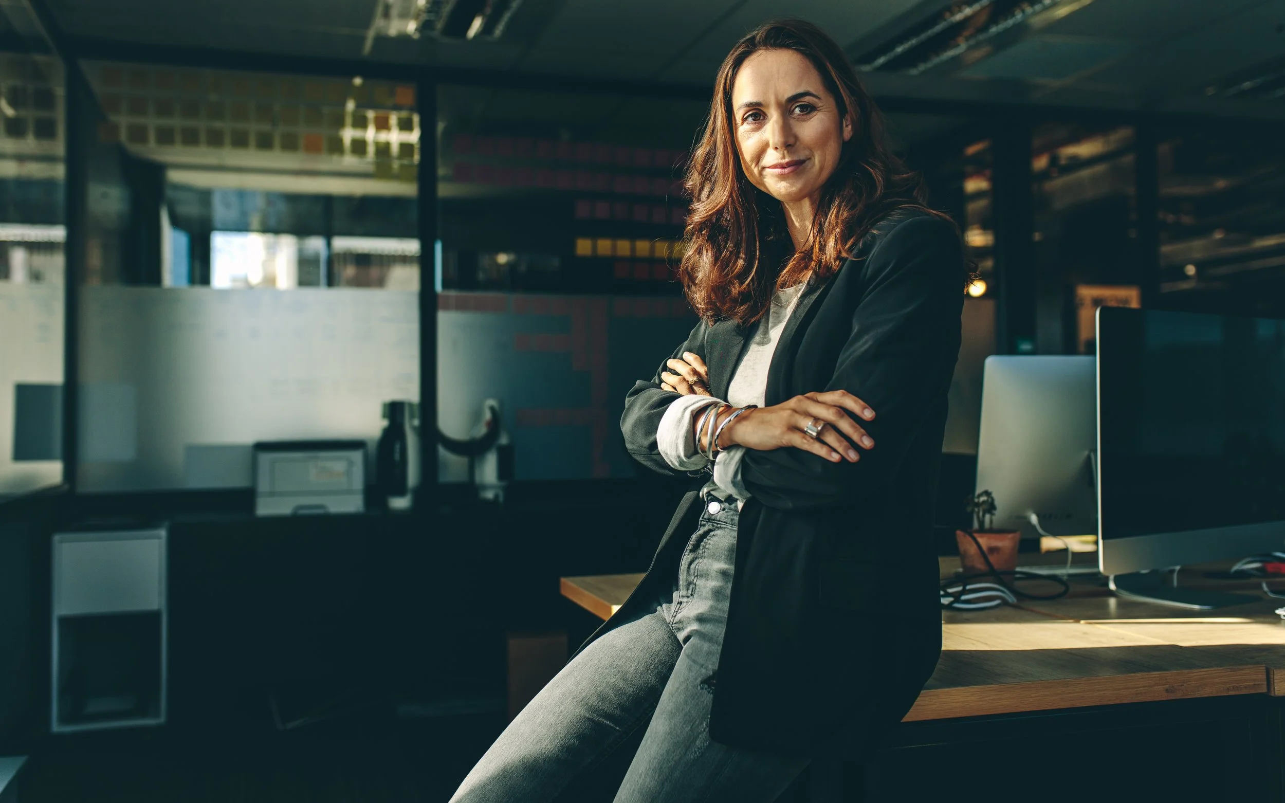 Confident businesswoman standing in her office, representing self-employed women building Social Security credits