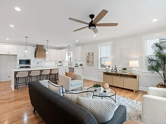 Open-concept living room and kitchen professionally staged by VIBE Designs in Greenville, SC.