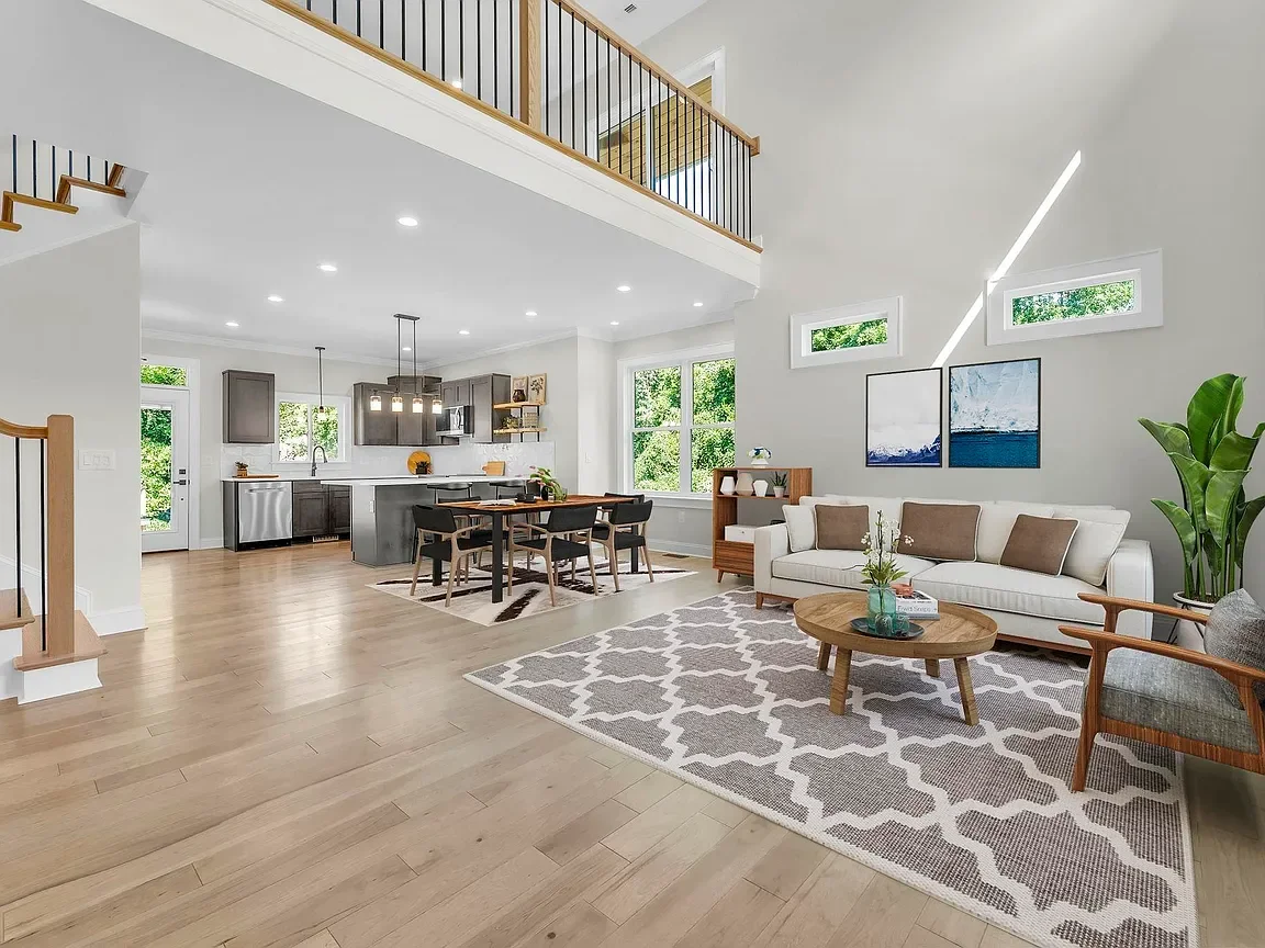 Open-concept living room and kitchen professionally staged by VIBE Designs in Greenville, SC.