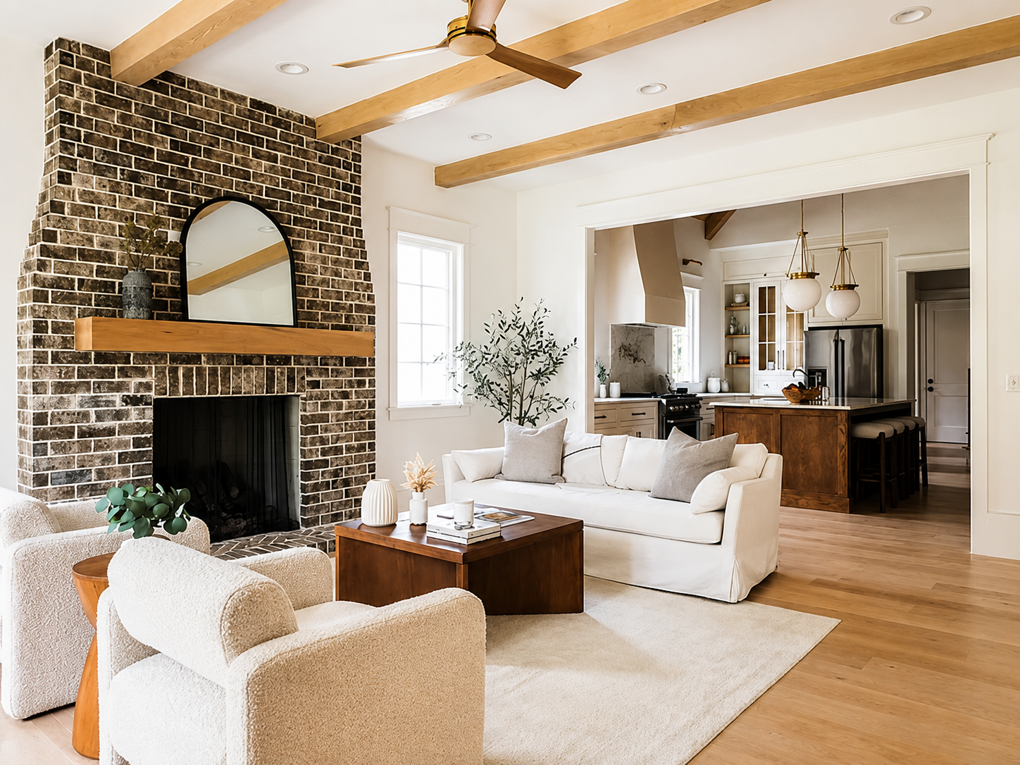 Modern living room with a brick fireplace, professionally staged by VIBE Designs in Greenville, SC.