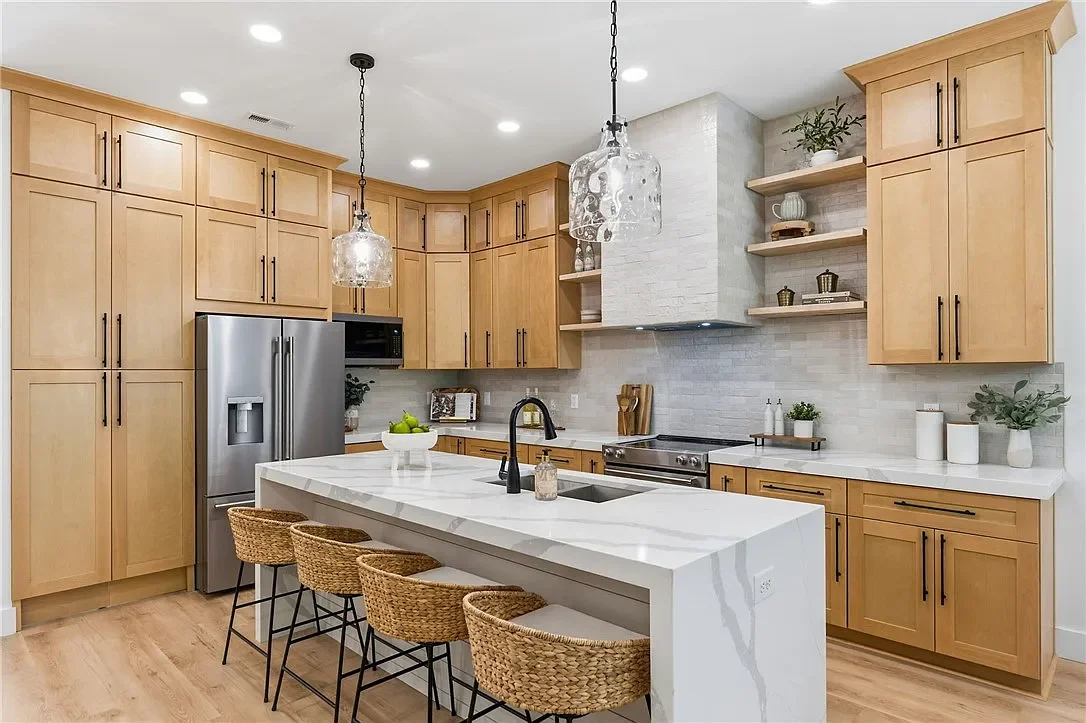 Modern kitchen with light wood cabinets, professionally staged by VIBE Designs in Greenville, SC.