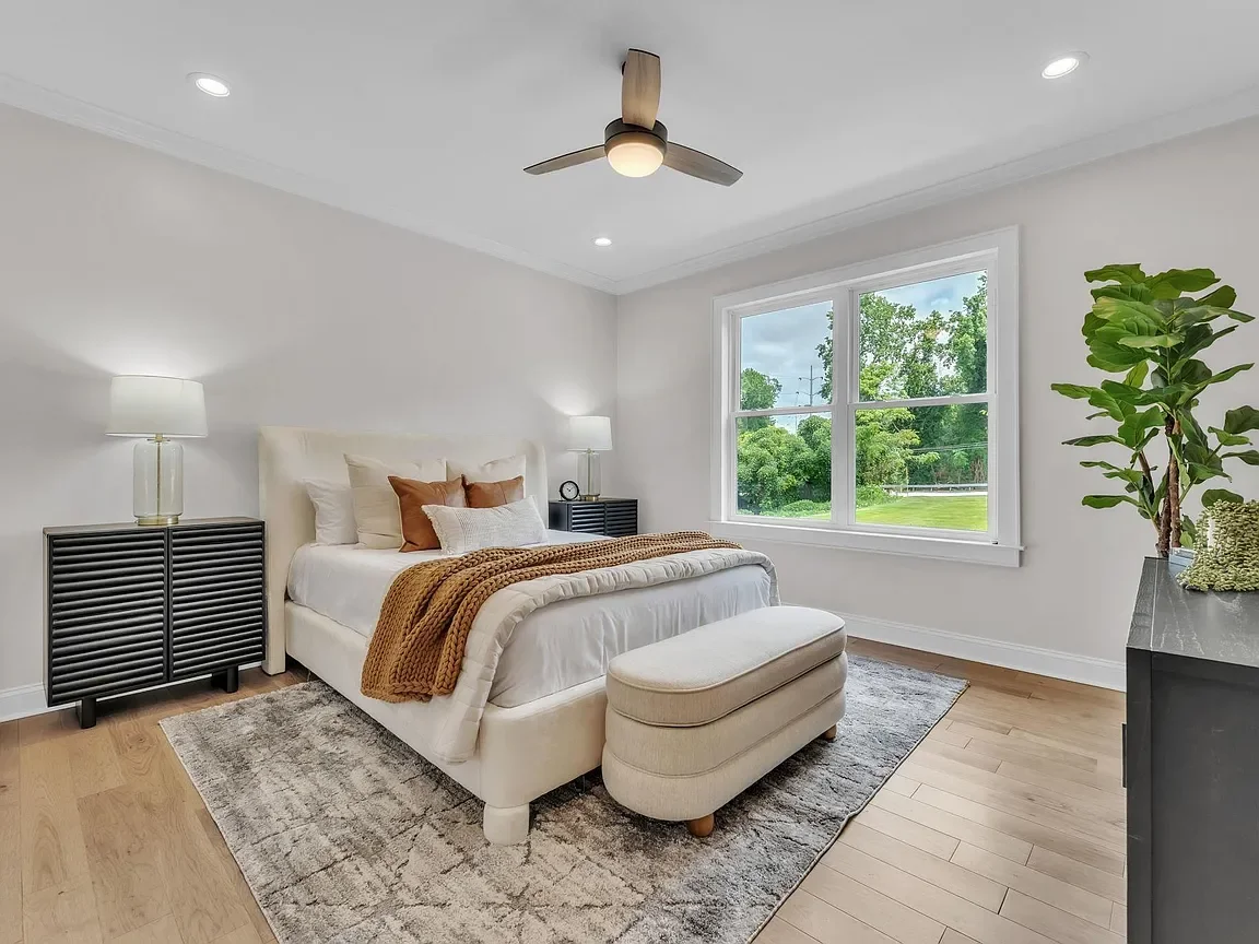 A bright bedroom professionally staged by VIBE Designs in Greenville, SC.