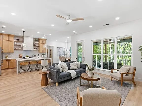 Open-concept living room and kitchen professionally staged by VIBE Designs in Greenville, SC.