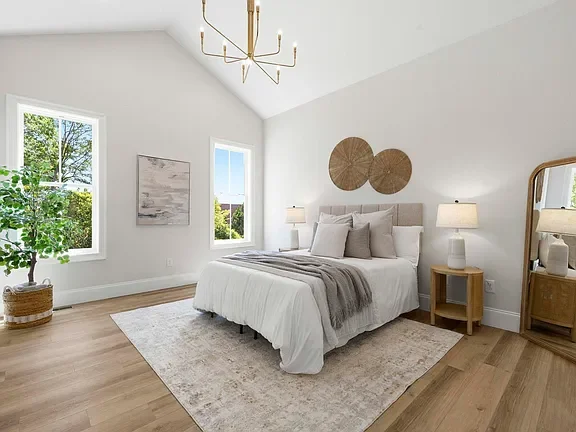 Bright, minimalist bedroom professionally staged by VIBE Designs in Greenville, SC.