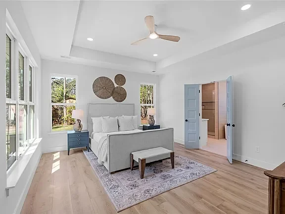 Bright bedroom professionally staged by VIBE Designs in Greenville, SC.