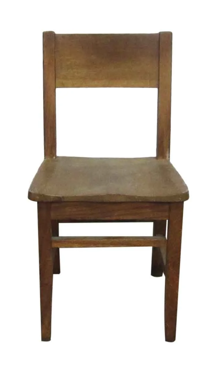 A wooden chair with a tall backrest, flat seat, and four legs, isolated on a white background.