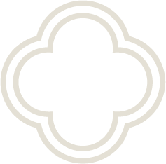 A black and white outline of a quatrefoil shape with a decorative border.