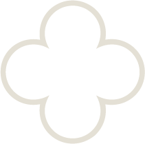 A black icon of a four-leaf clover with rounded edges, outlined in white.