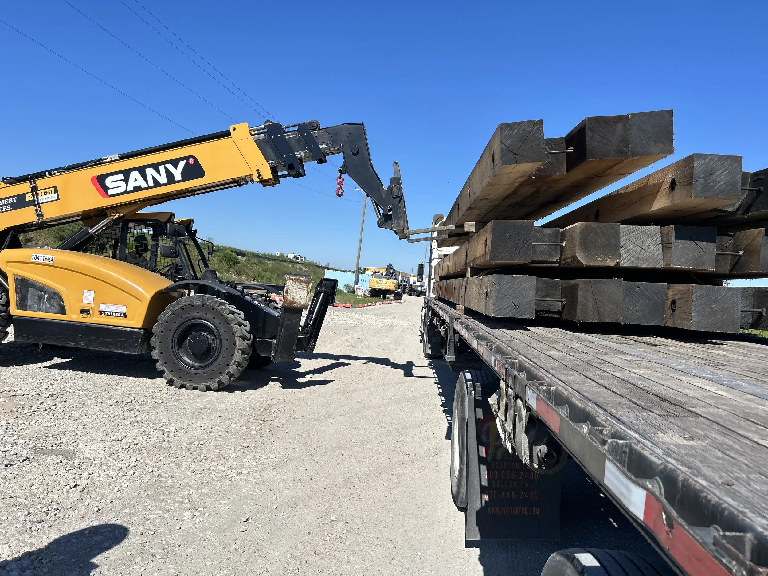 telehandler unloading 30' hardwood crane mats at the Port Arhtur Shoreline improvement project in Texas