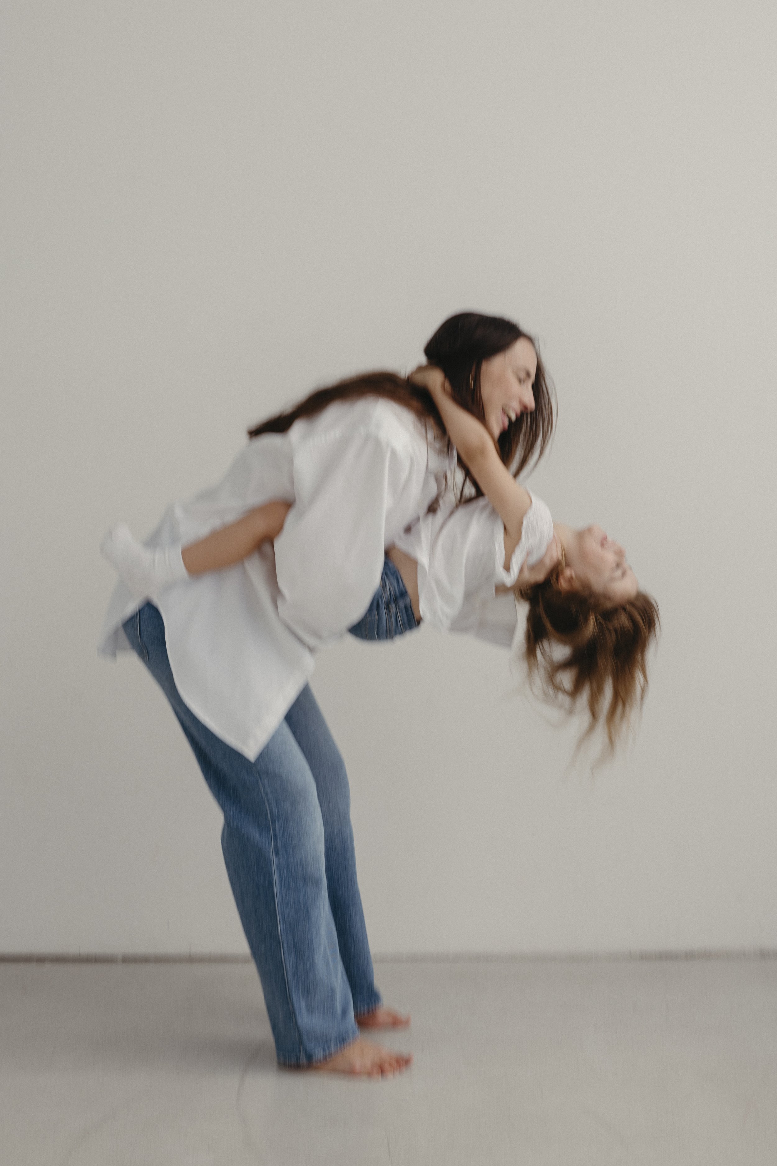 Tania Gnecchi playing with her daughter, host of the Matrescence Diaries podcast